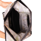 Top-down view into the open Forest Camo Dry Pocket backpack, showing the wide opening and interior.