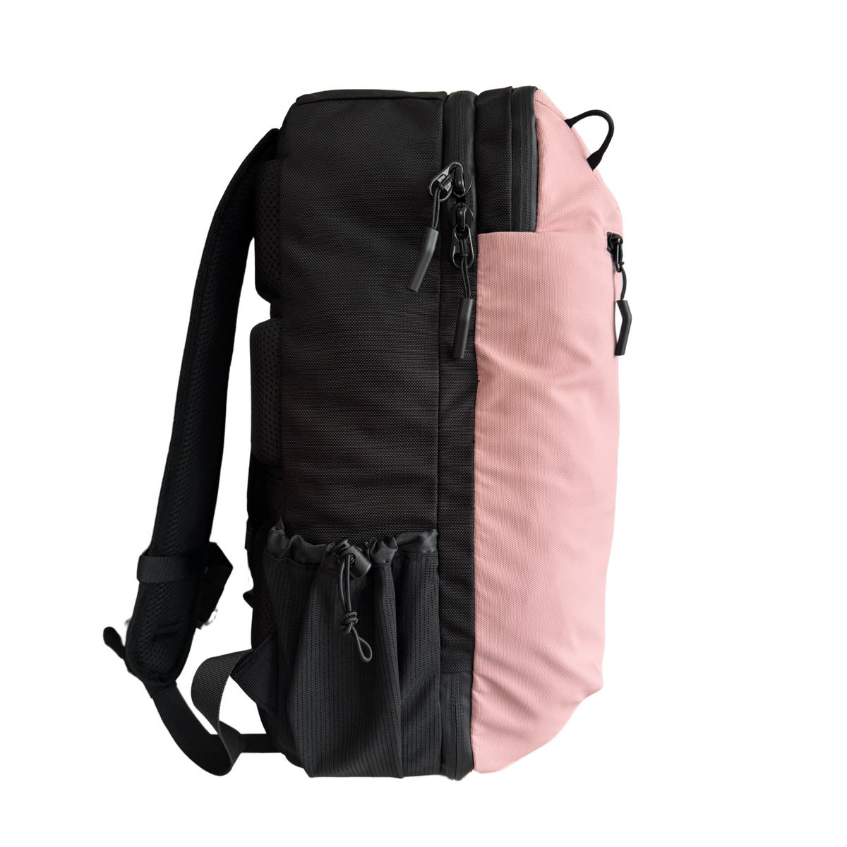 Side view of the pink backpack showing its depth, shoulder strap and bottle pocket.
