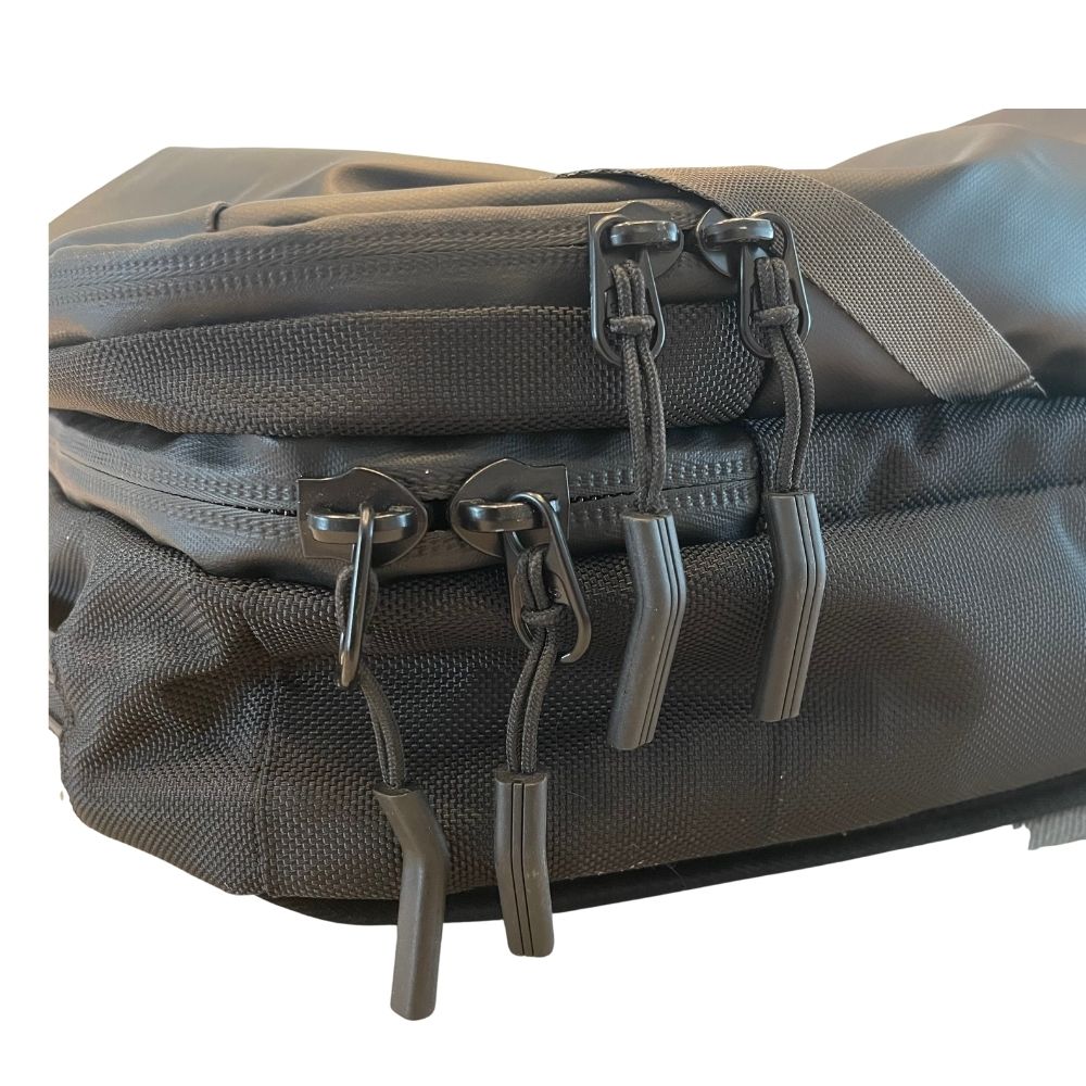 Close-up of the backpack zipper tracks and corded zipper pulls.